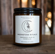 Candle jar with a label on a wooden surface