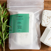 Packaged product with a green label on a wooden tray with herbs