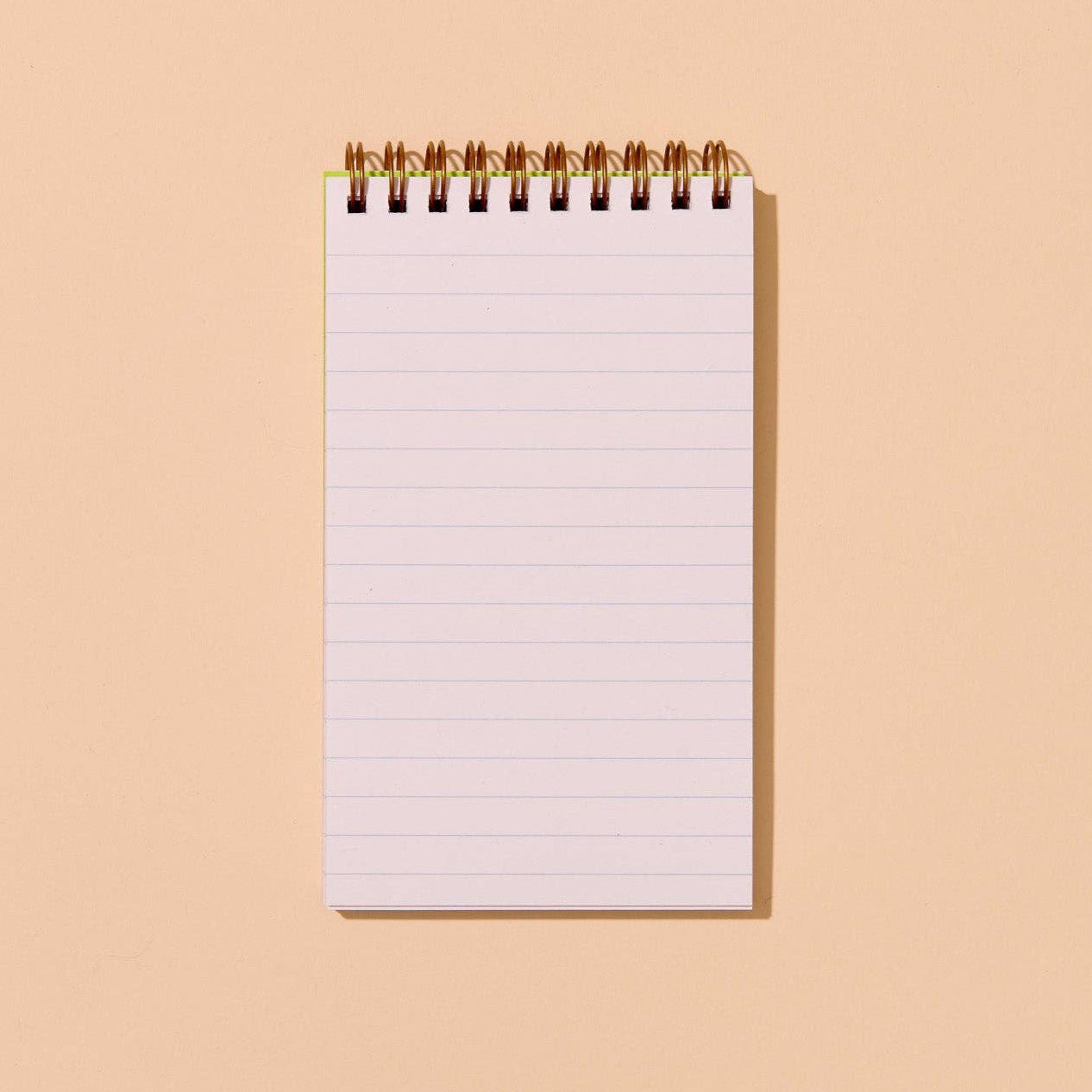 Blank notebook with lined pages on a beige background