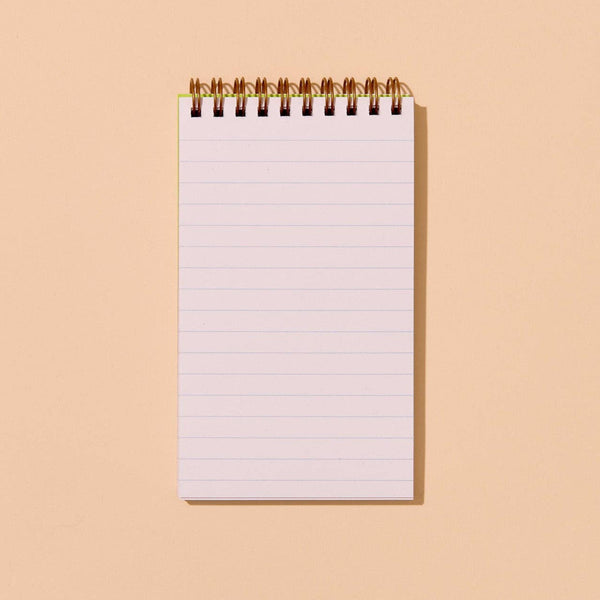 Blank notebook with lined pages on a beige background