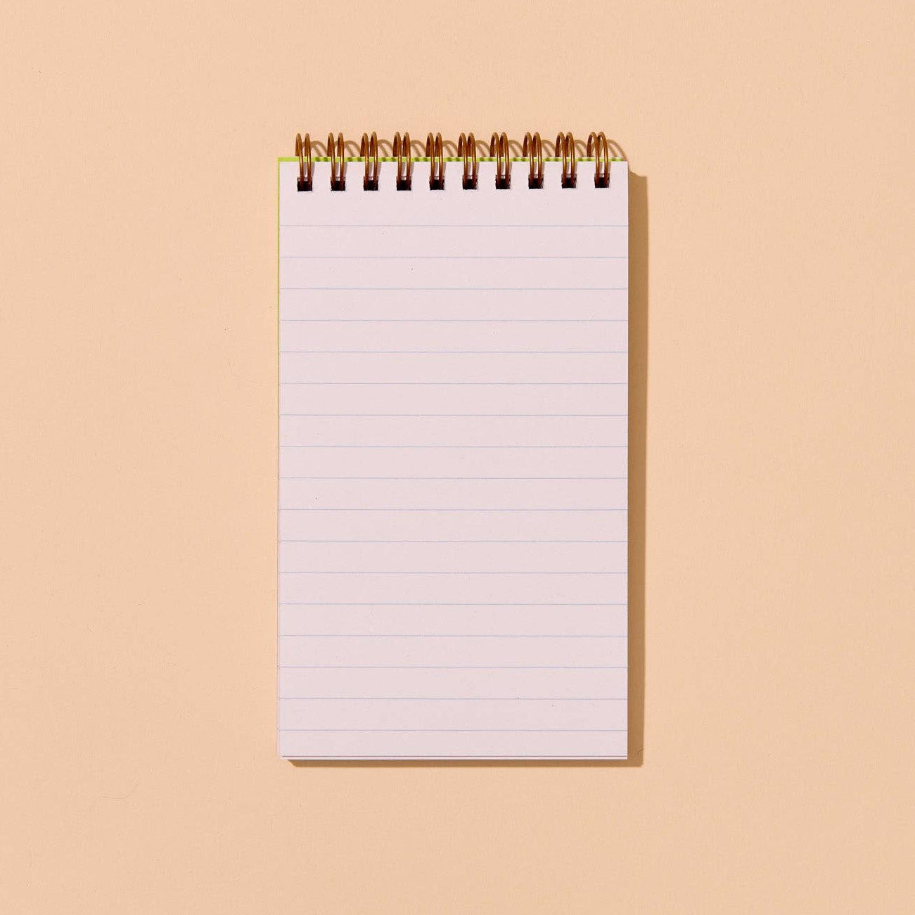 Blank notebook with lined pages on a beige background