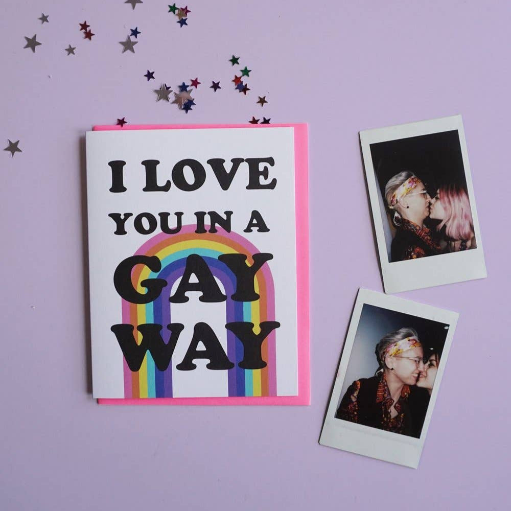 Card with 'I LOVE YOU IN A GAY WAY' text and rainbow design on a purple background with confetti.