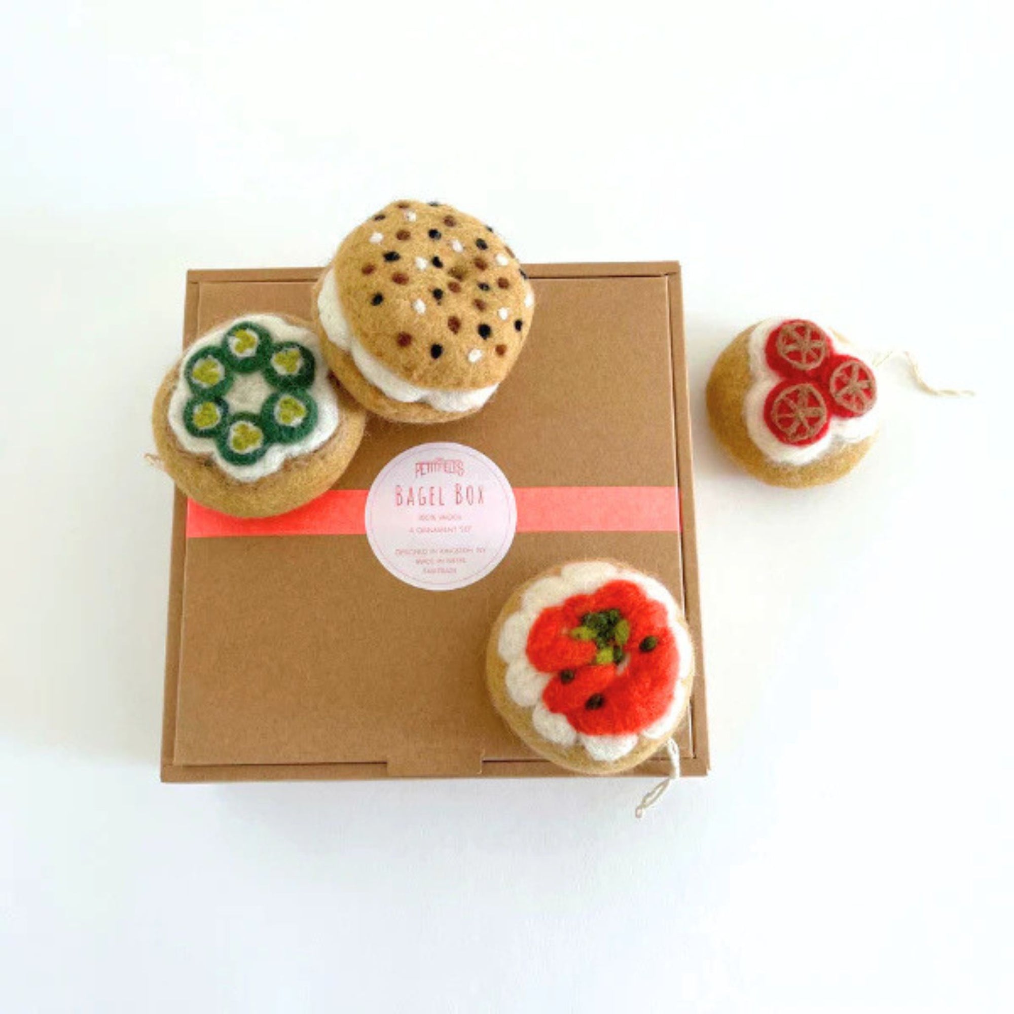 A box of bagel shaped felt holiday ornaments