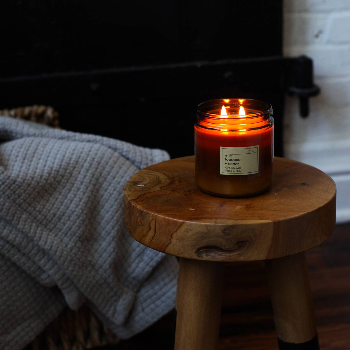 Candle on a wooden stool with a blurred background