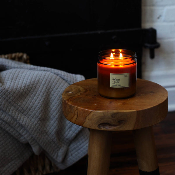 Candle on a wooden stool with a blurred background
