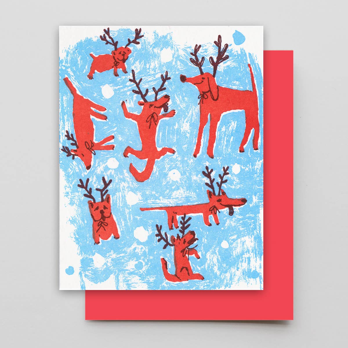 Card with red dog with raindeer horns design on a blue and white background