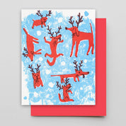 Card with red dog with raindeer horns design on a blue and white background