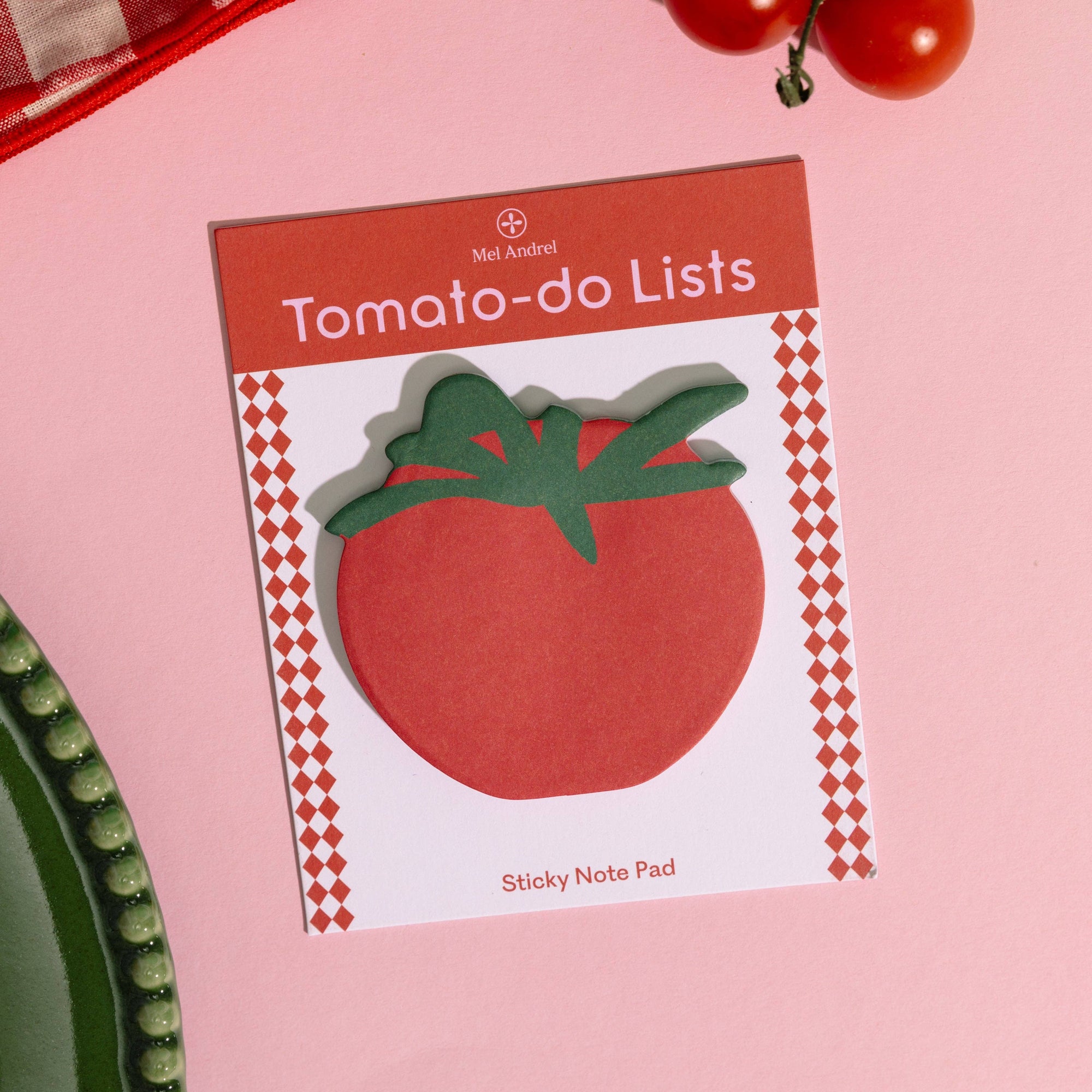 Sticky note pad with tomato design on a pink background