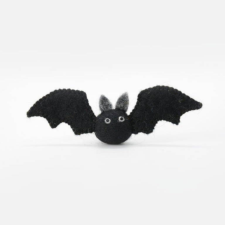 A small black felt bat toy with gray inner ears and white bead eyes, shown against a plain white background.