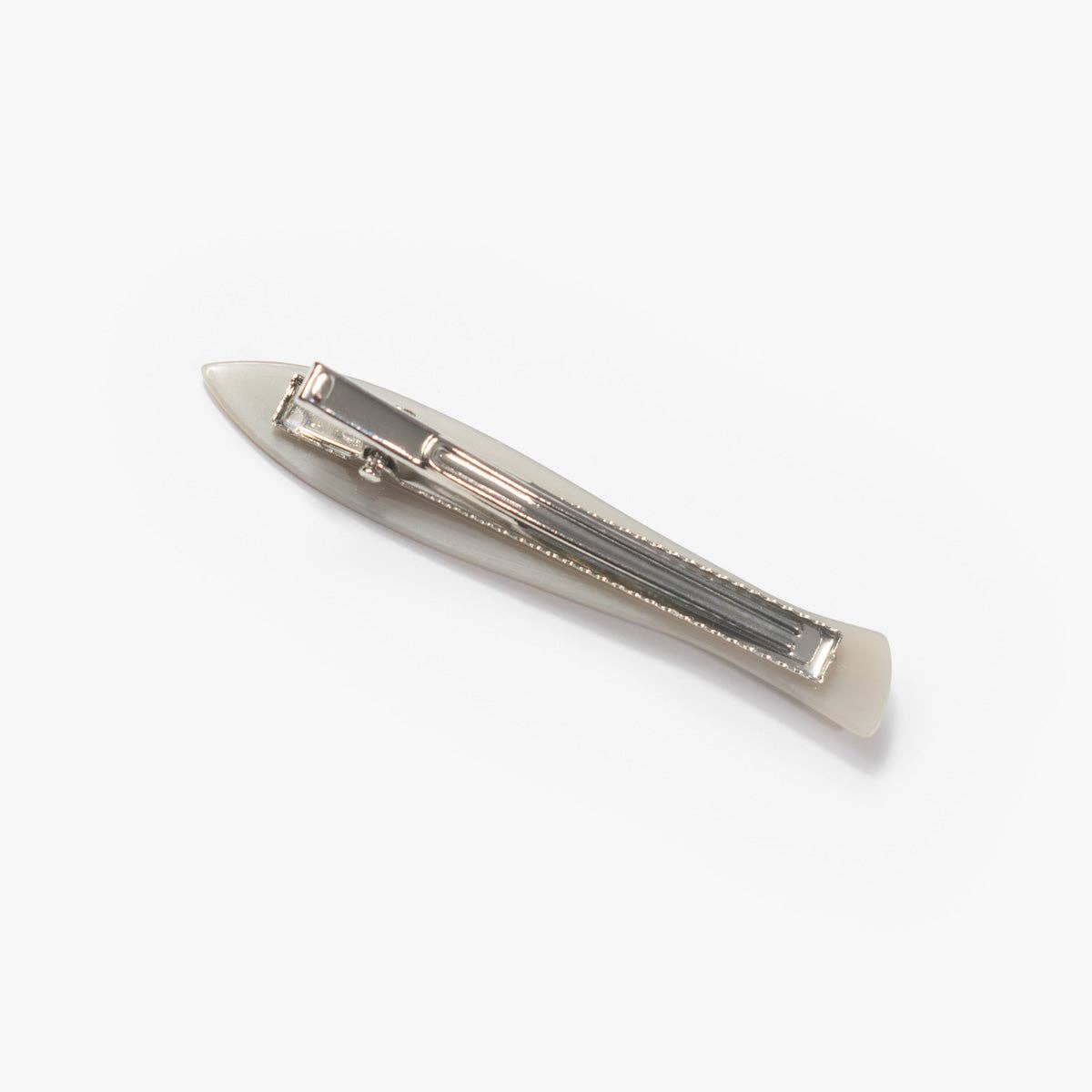 The back of a silver fish barrette on a white background