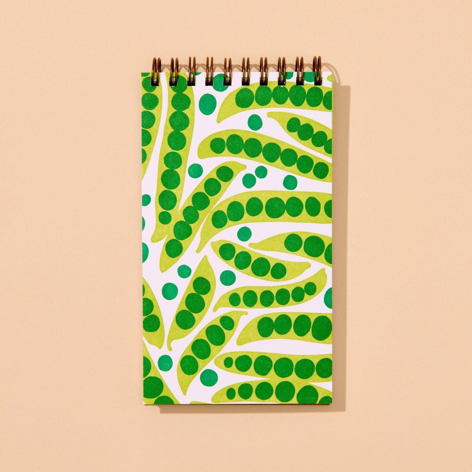Notebook with green and yellow pattern on a beige background