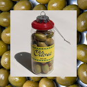 Decorative ornament shaped like a jar of olives with a red lid on a white background with olives around the edge
