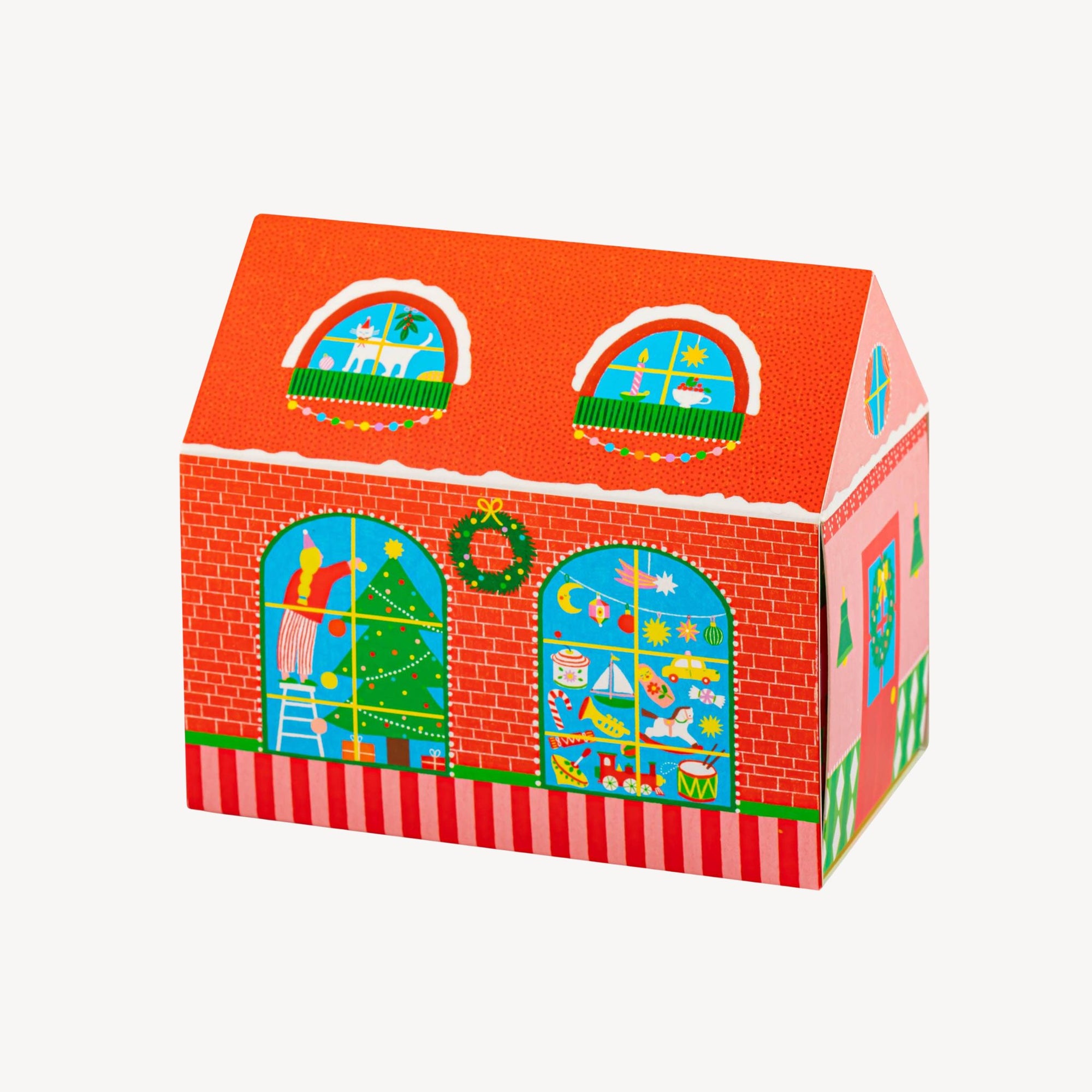 Colorful matchbox in the shape of a  house with window designs on a white background