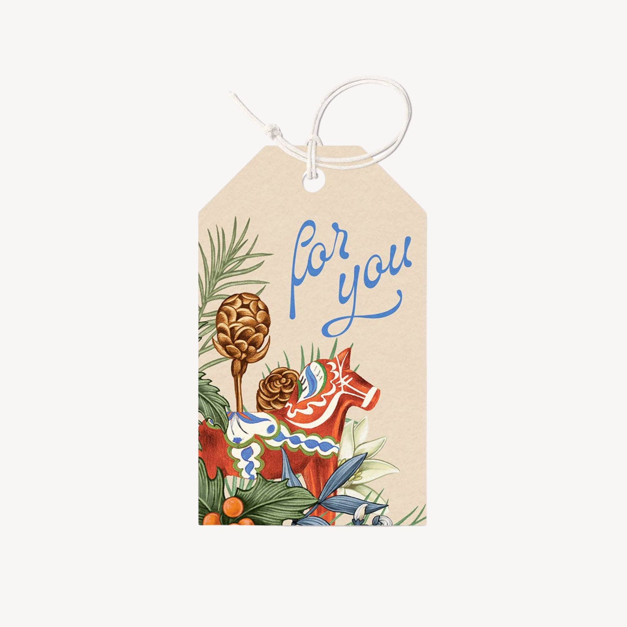 Gift tags with holiday foliage and a toy horse on a plain background.