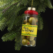 Decorative Christmas ornament shaped like a jar of olives hanging on a tree branch.