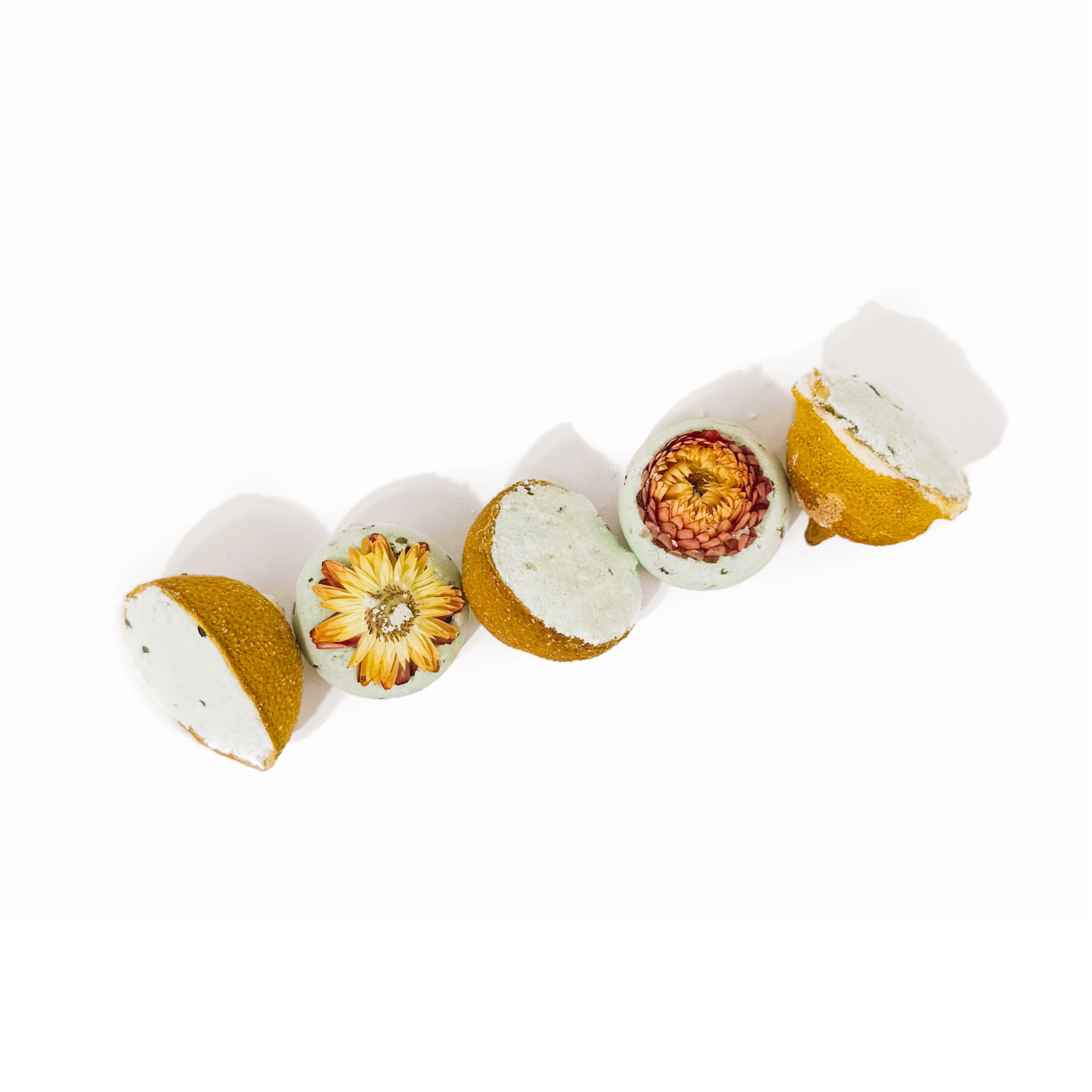 Decorative items resembling small pots with floral designs on a white background