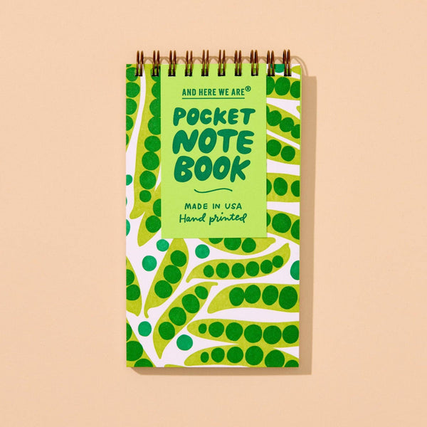 Pocket notebook with green and white pea  pod pattern on a beige background