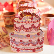 Decorative cake with intricate designs on a table with blurred background