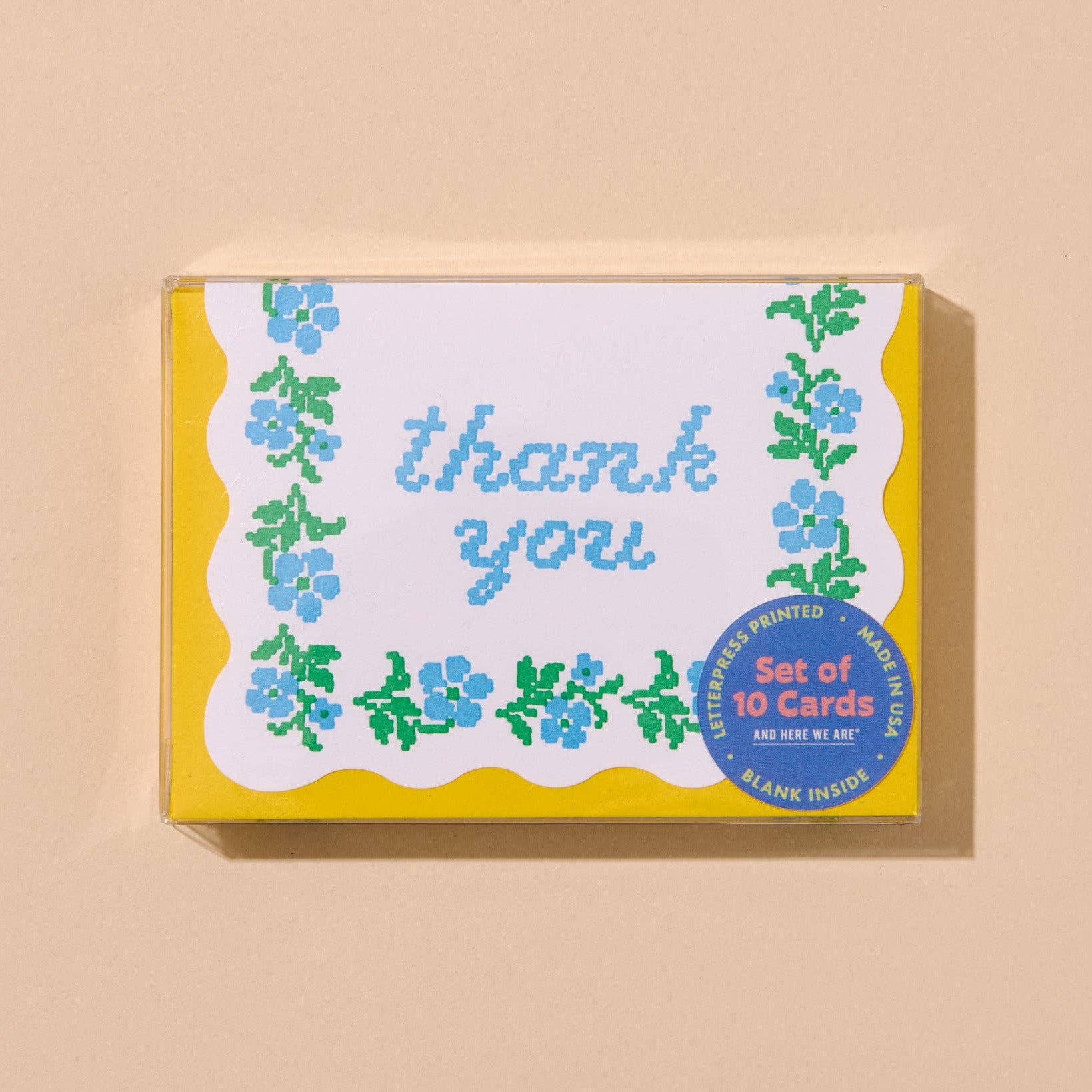 Box of 'thank you' cards with floral design on a beige background