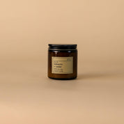 Candle jar with a label on a beige background