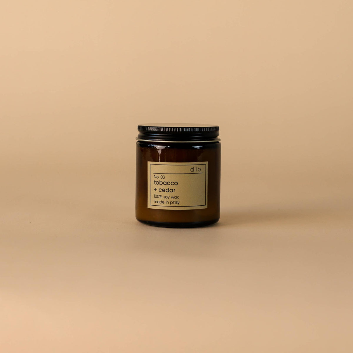 Candle jar with a label on a beige background