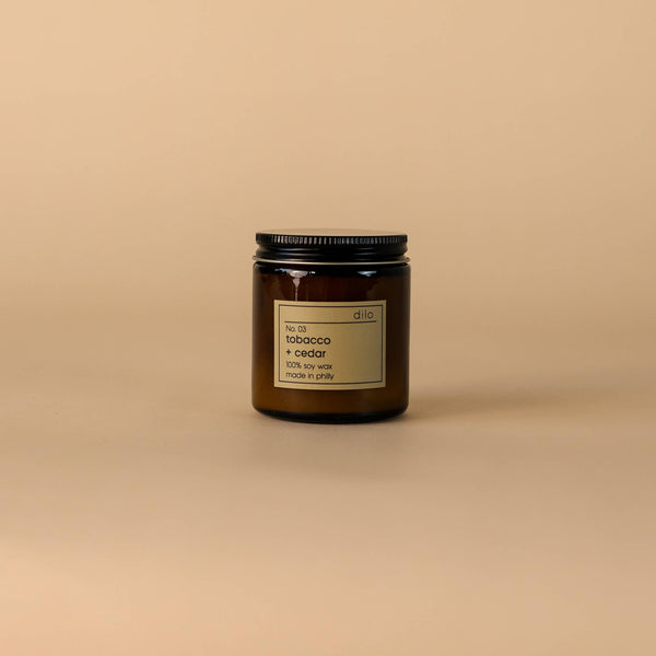 Candle jar with a label on a beige background