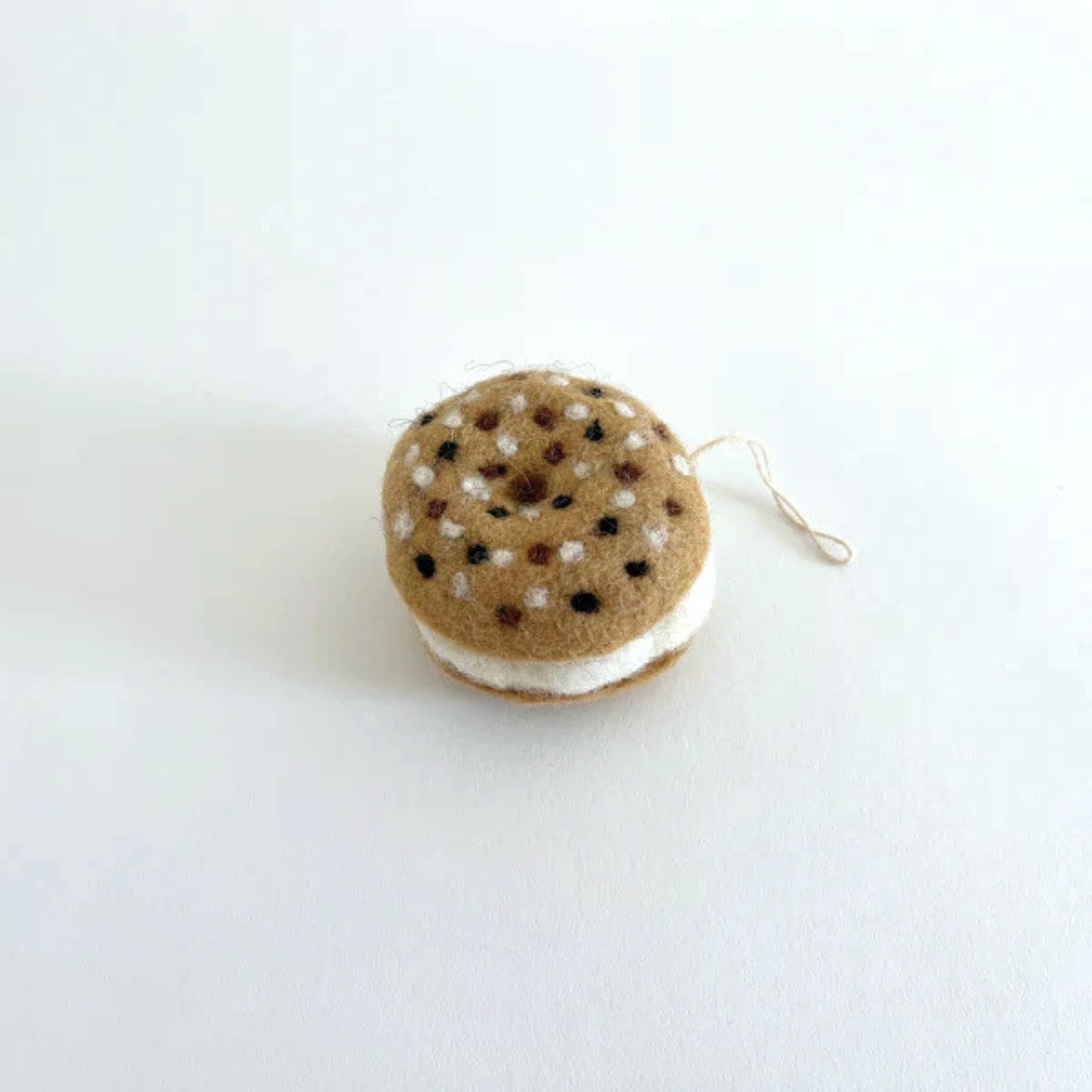 A box of bagel shaped felt holiday ornaments