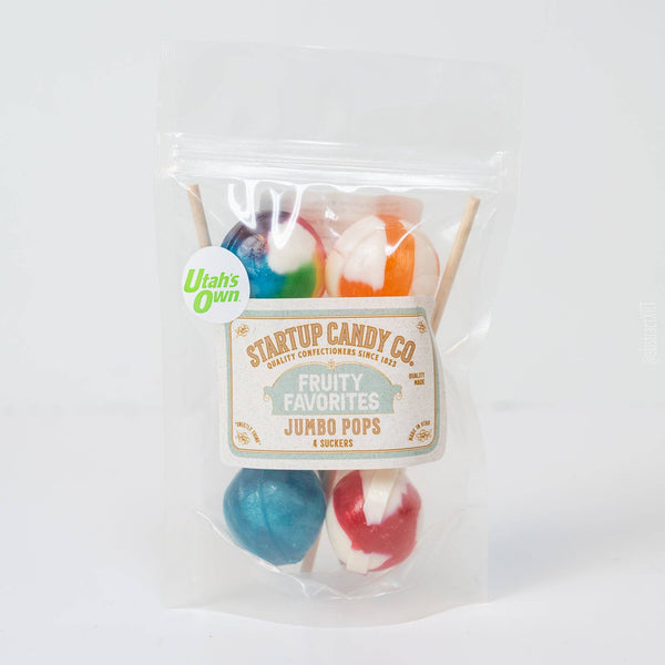 A clear stand-up pouch containing four jumbo pops lollipops in assorted colors, with a front label reading Startup Candy Co. Fruity Favorites Jumbo Pops.
