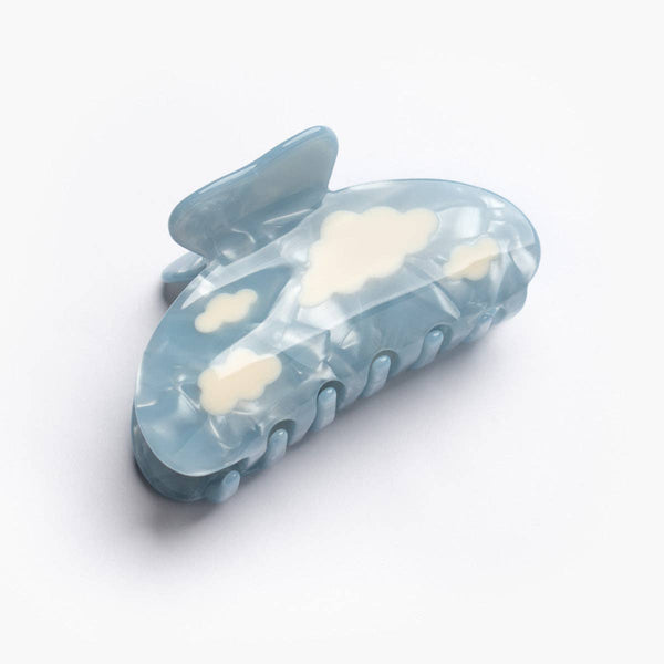 Blue hair clip with cloud designs on a white background
