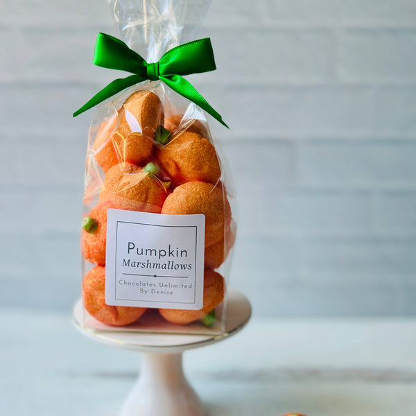 A package of orange pumpkin-shaped marshmallows with a label that reads "Pumpkin Marshmallows Chocolates Unlimited by Denise"