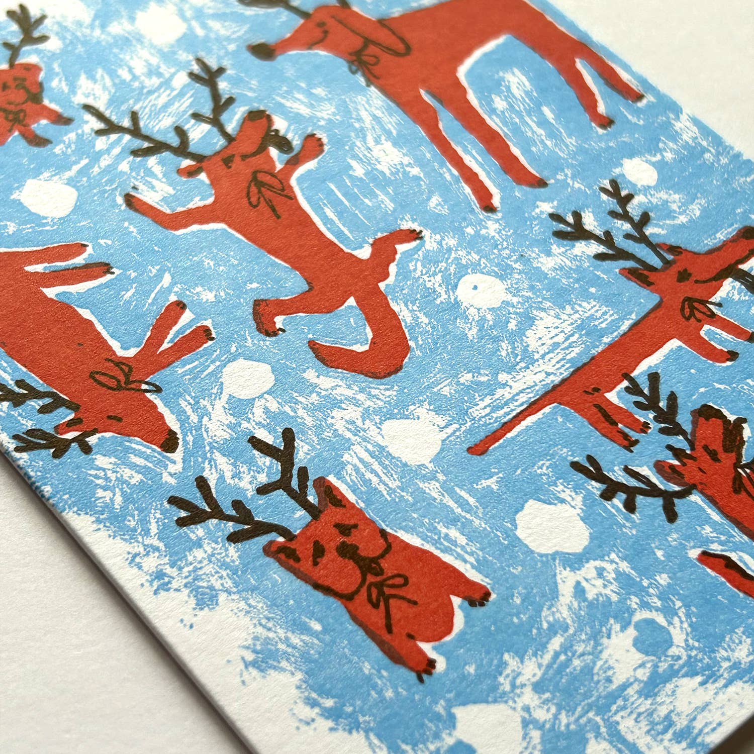 Pattern of red dogs with antlers on a blue and white background