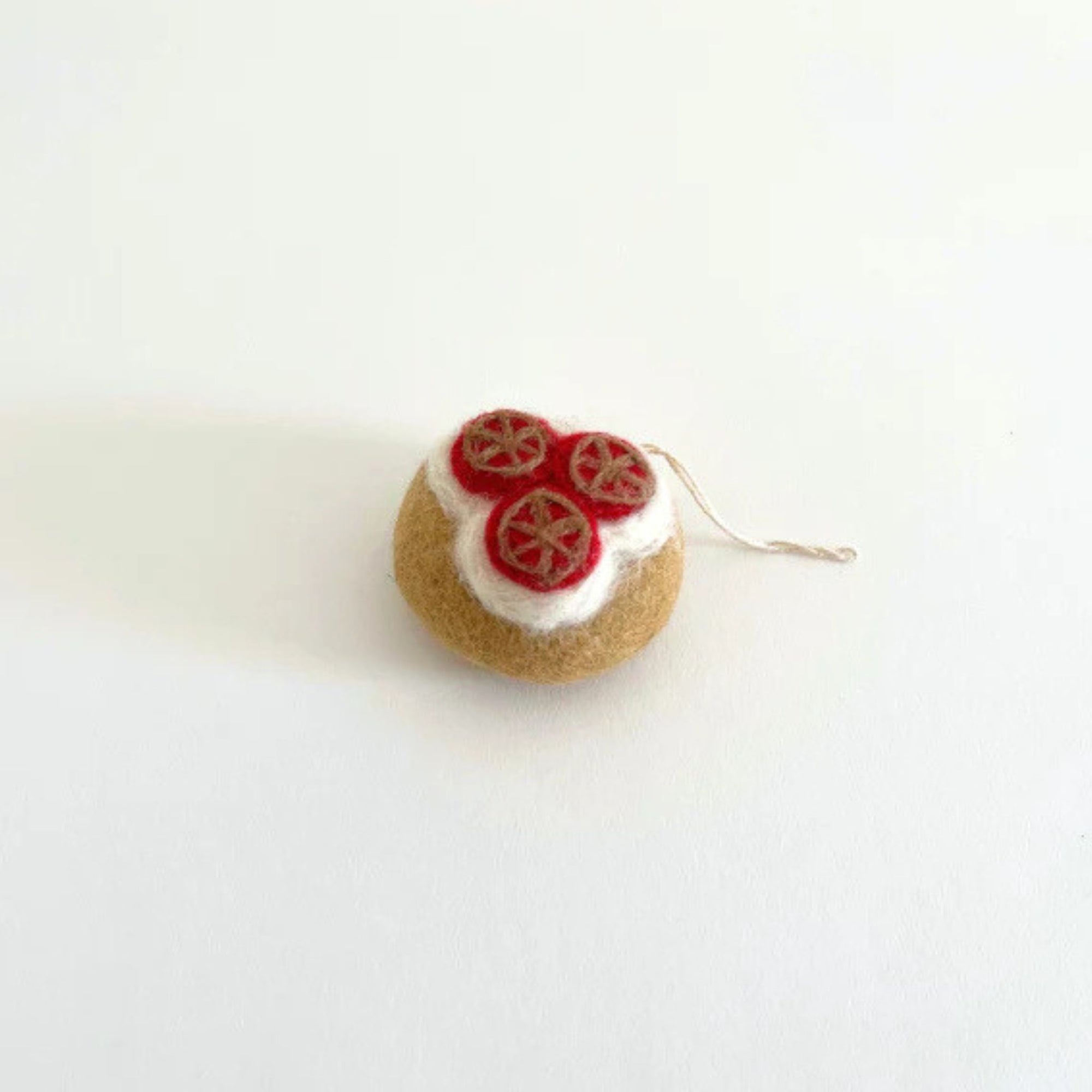 A box of bagel shaped felt holiday ornaments