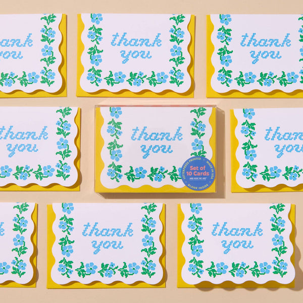 Set of 'thank you' cards with floral designs on a beige background