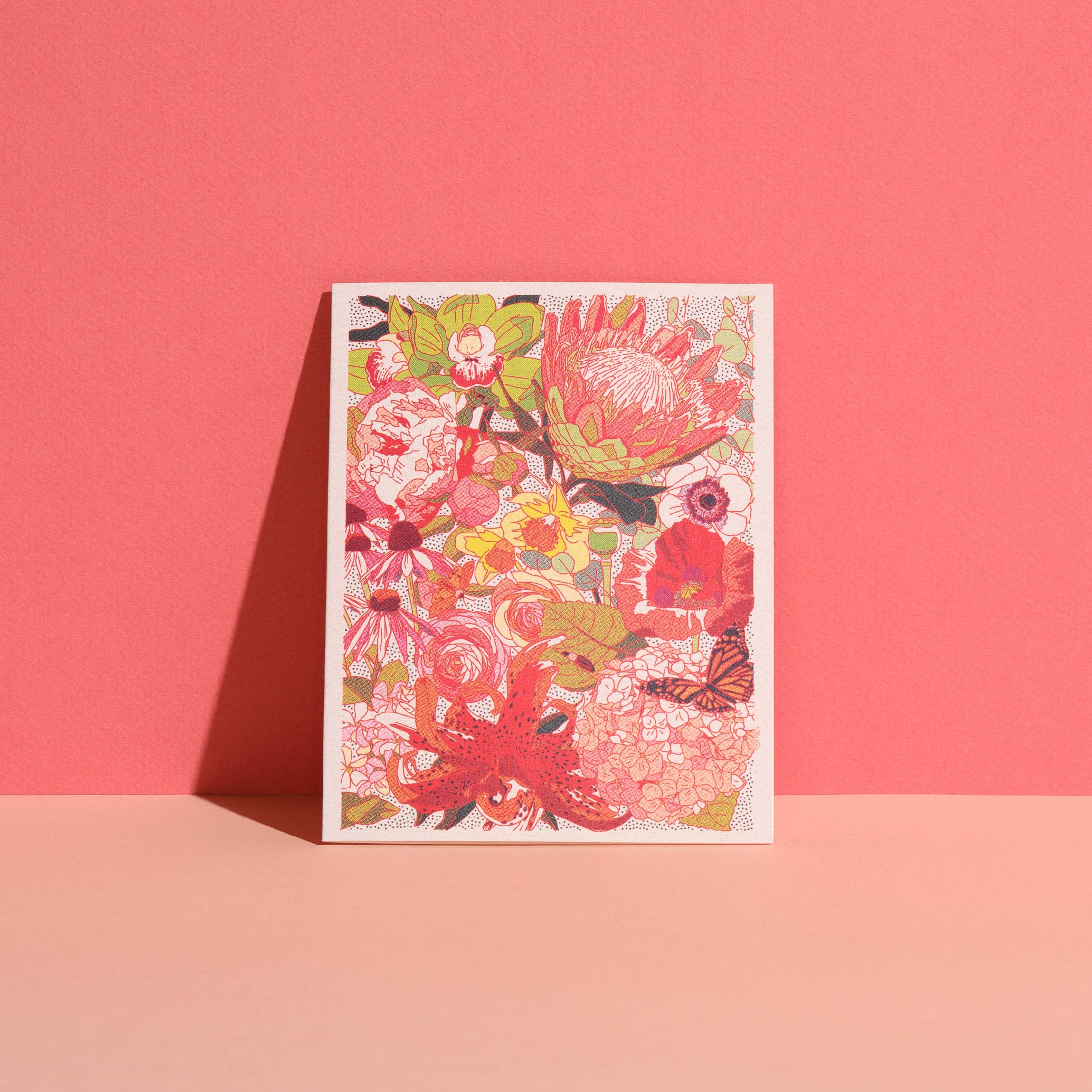 Colorful floral design on a white card against a pink background