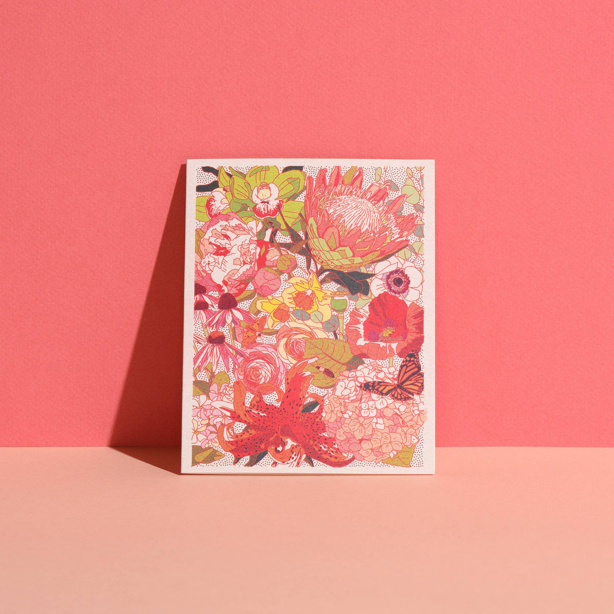 Colorful floral design on a white card against a pink background
