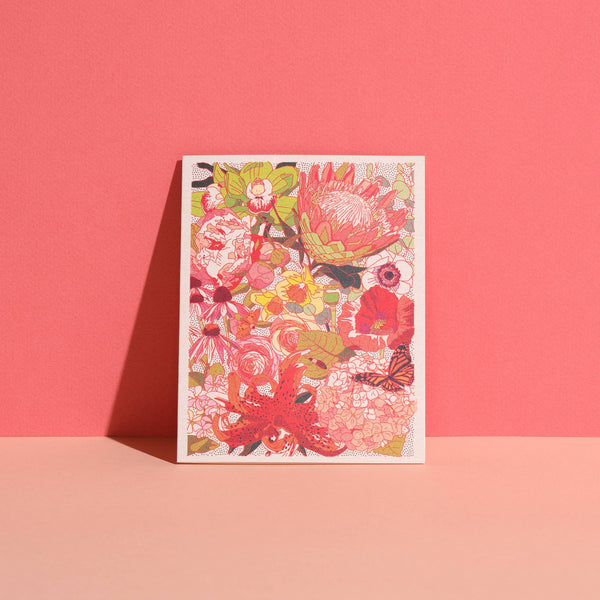 Colorful floral design on a white card against a pink background