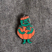 Pumpkin character pin on a denim background