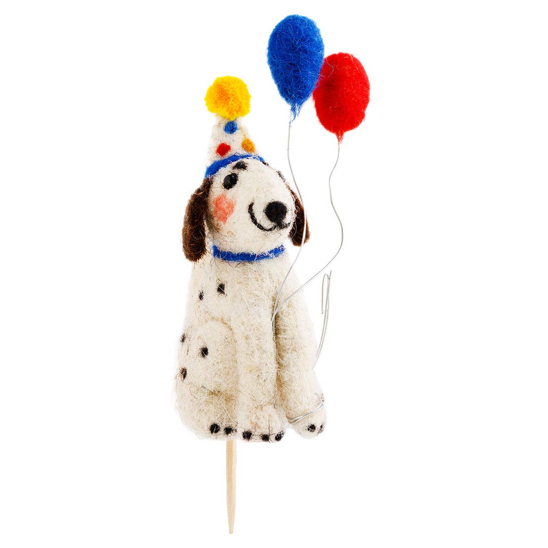 Felted dog cake topper with colorful balloons on a white background