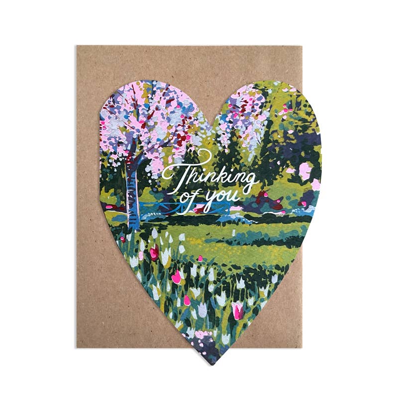 Heart-shaped card with floral design and 'Thinking of you' text on a brown background