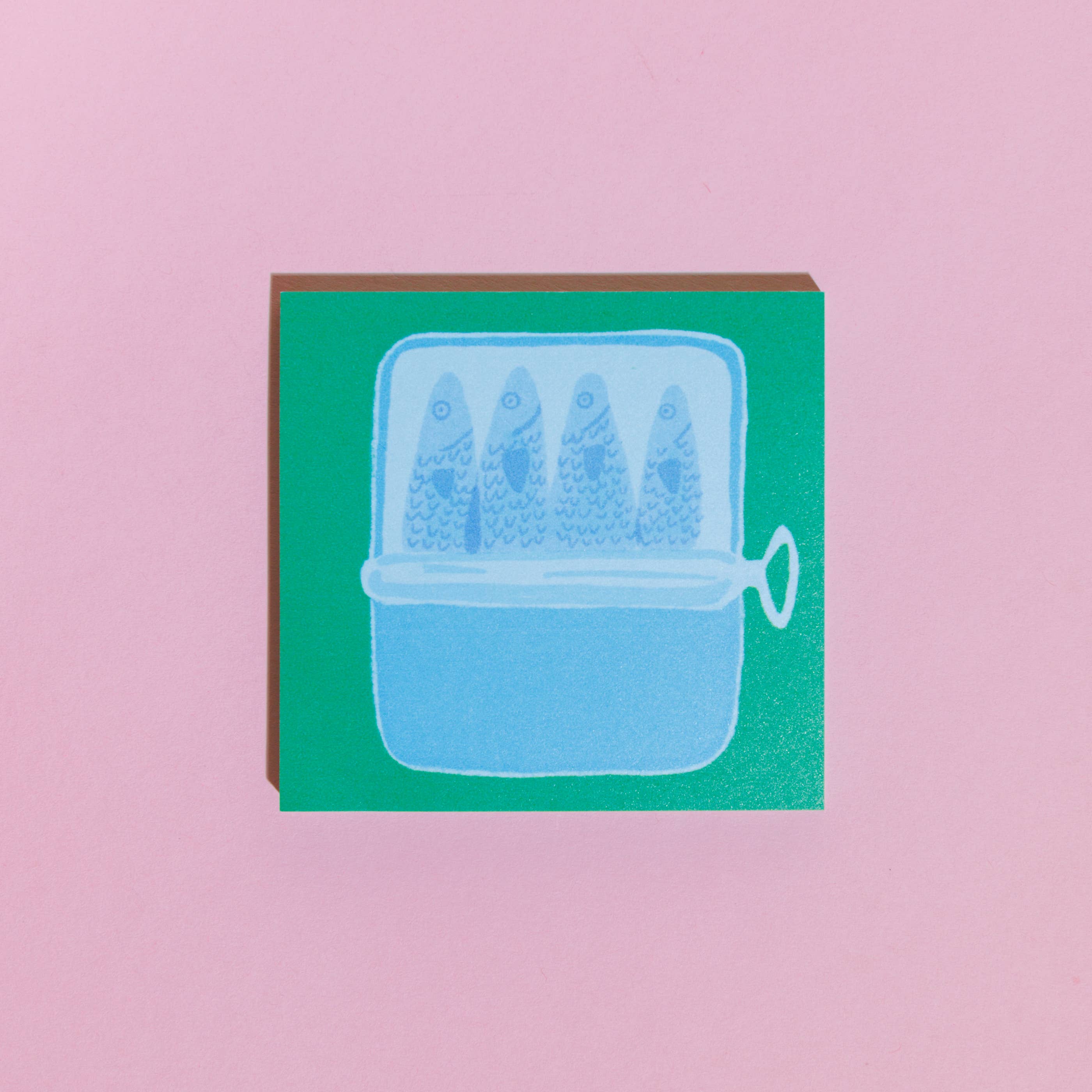 Card with a blue illustration of a fishbowl containing three fish on a pink background