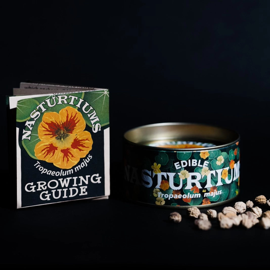 Edible nasturtiums in a tin with a growing guide on a black background