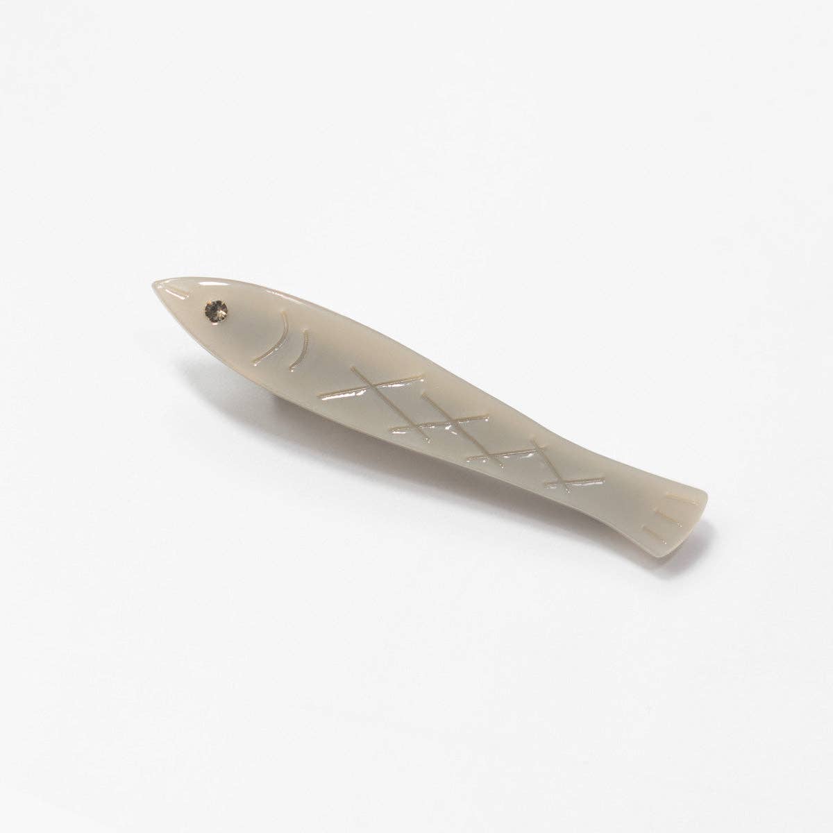 Fish-shaped barrette on a white background