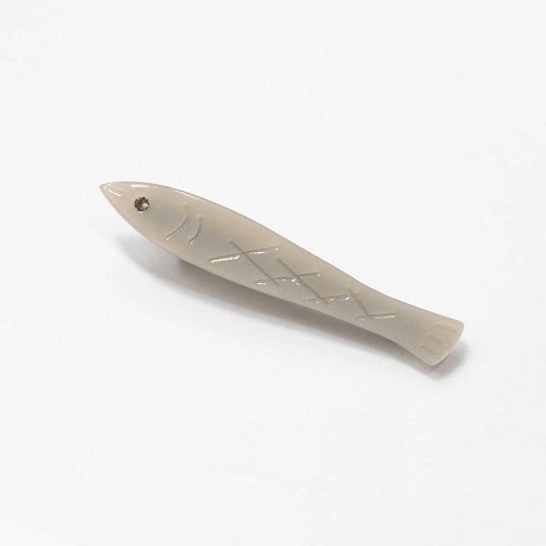 Fish-shaped barrette on a white background