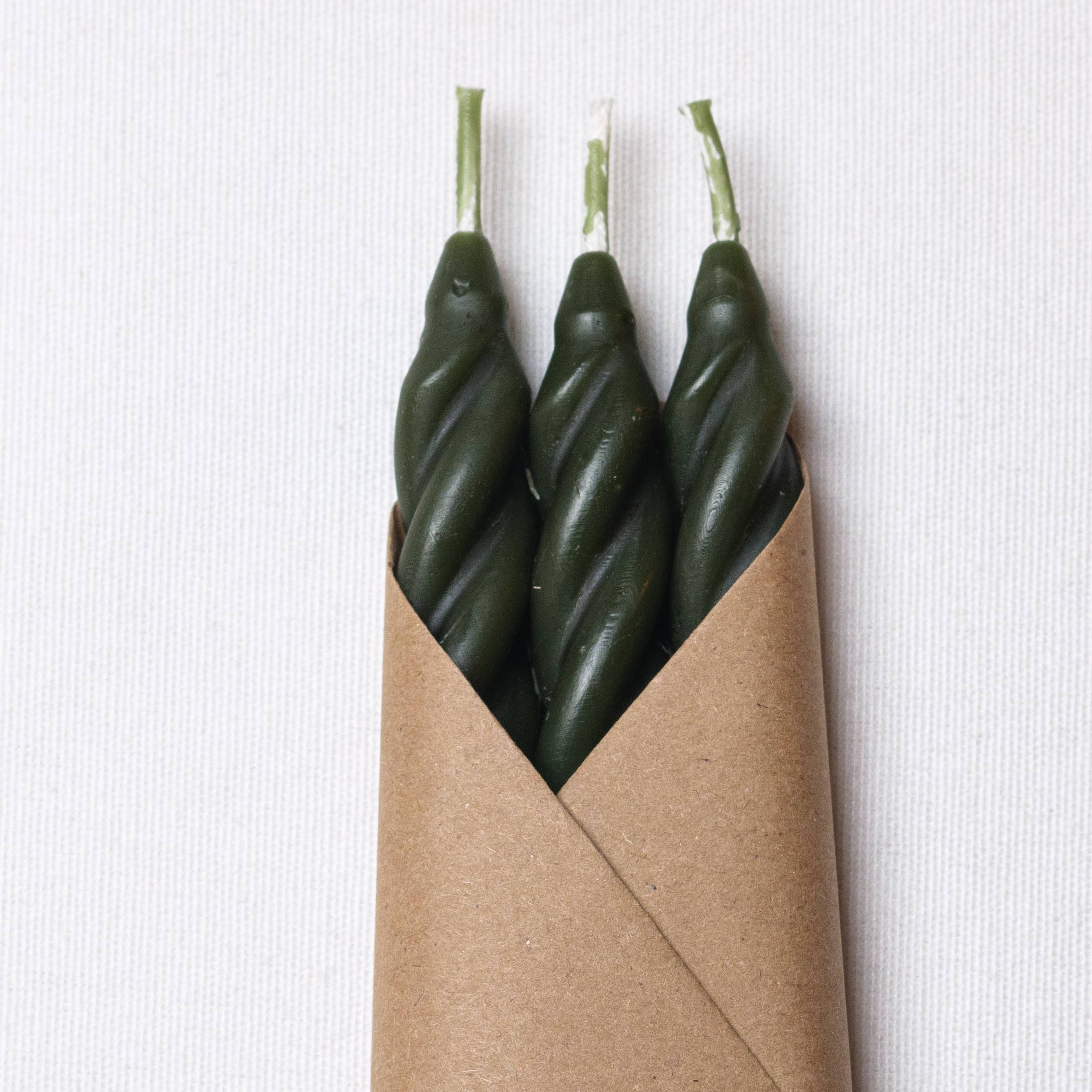 Set of three pine beeswax spiral taper candles from Cave Glow Studio, featuring natural beeswax with twisted spiral design.