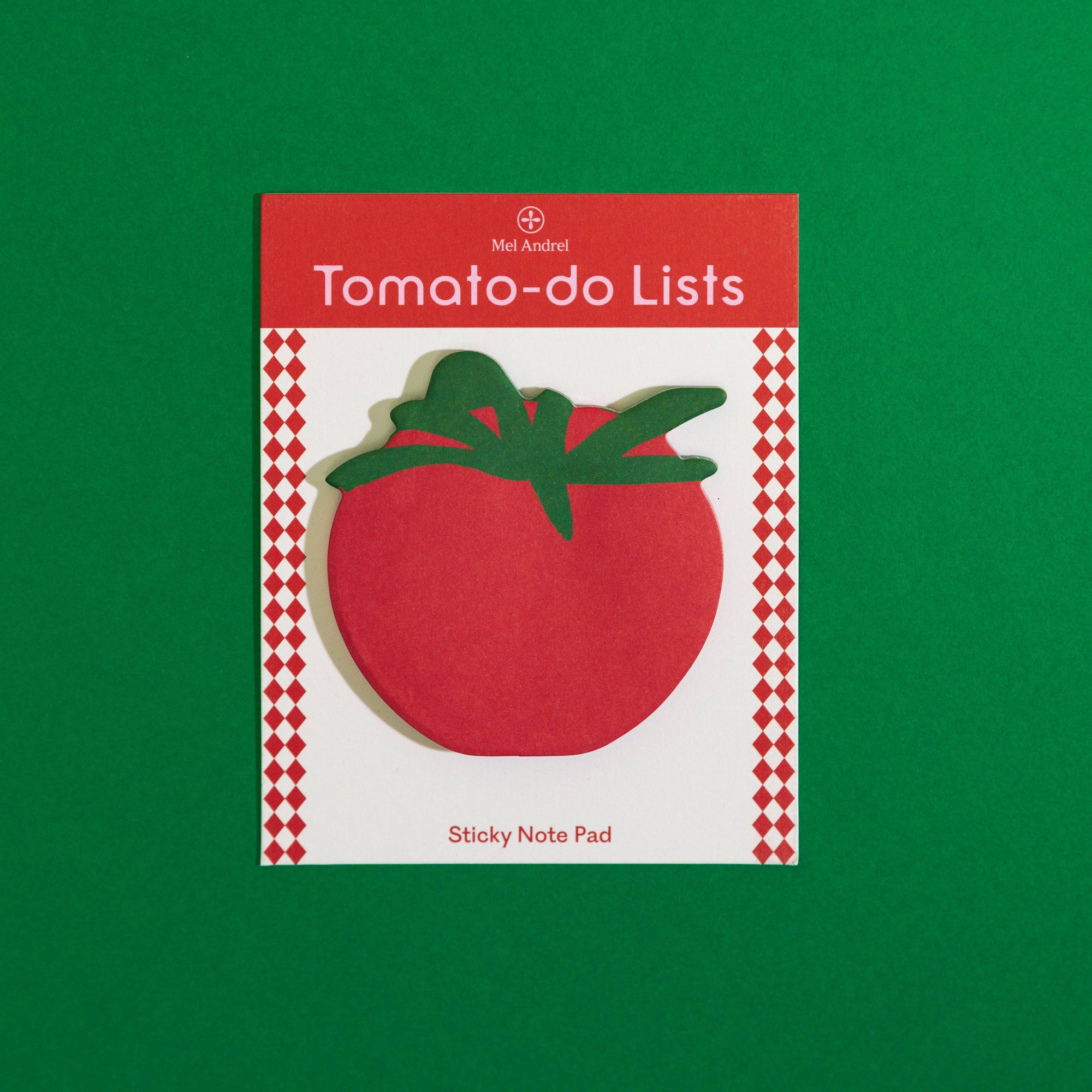 A tomato-shaped sticky note pad on a white card with red text reading 'Tomato-do Lists' and 'Sticky Note Pad,' photographed on a solid green background. The visible brand at the top is Mid-Audrey.