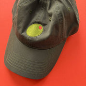 Green cap with a circular patch on a red background