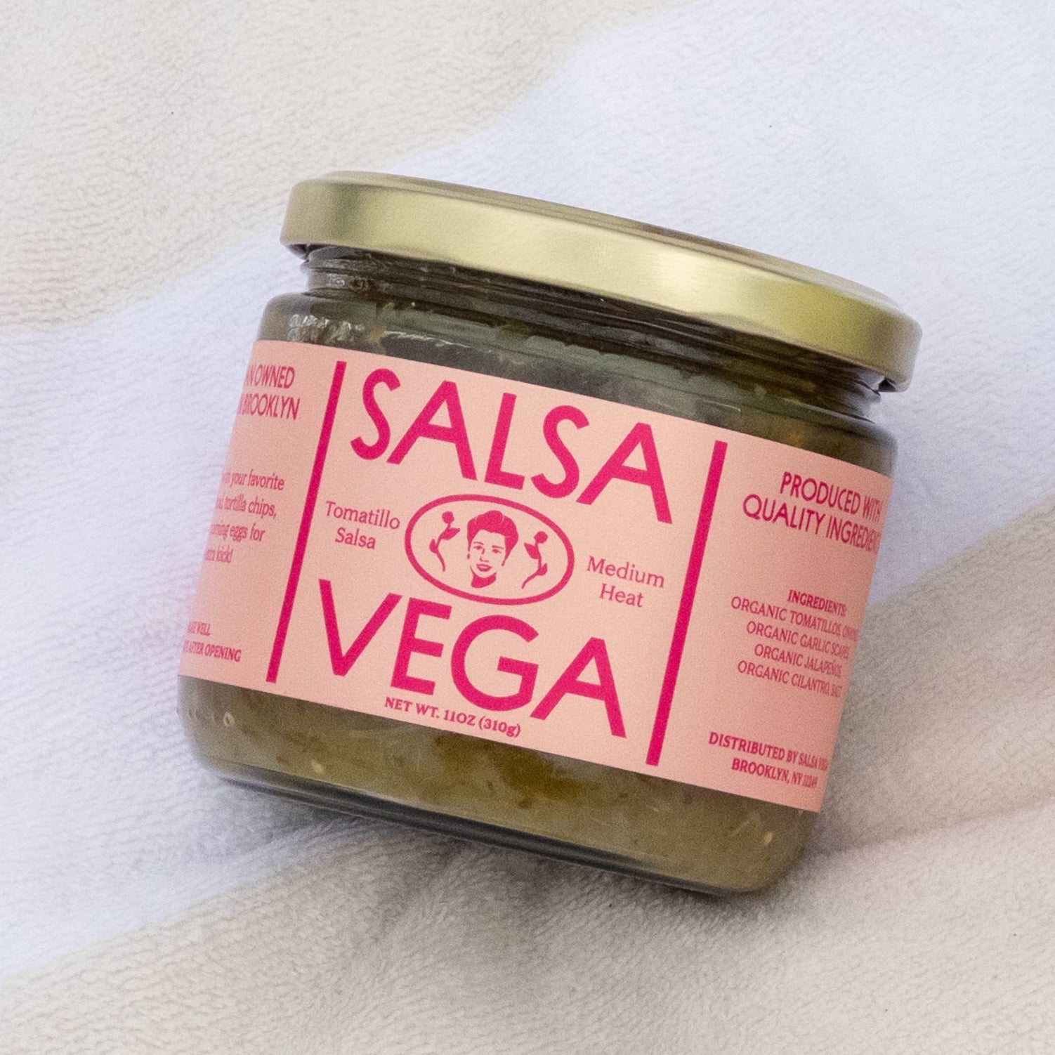 Salsa Vega Tomatillo Salsa in a jar, vibrant green condiment with fresh tomatillos, ideal for dipping or adding flavor to dishes.