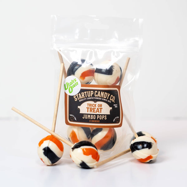 A bag of black, white and orange lollipops with a tag that reads "Startup Candy Co. Trick or Treats Jumbo Pops" against a white background