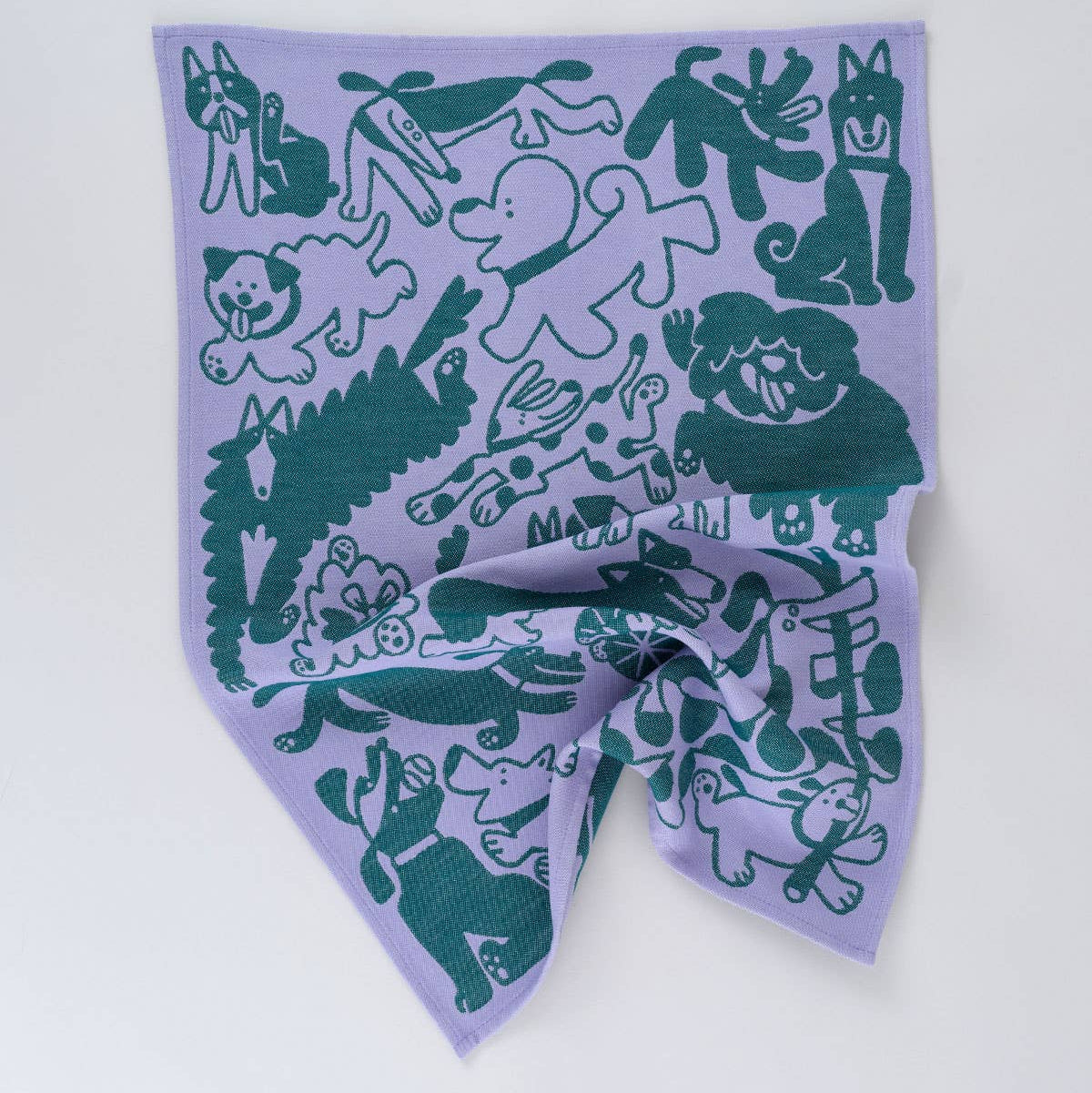 Purple tea towel with green animal illustrations on a white background