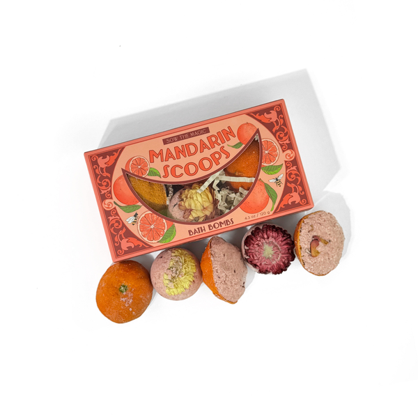 Box of Mandarin Scoops bath bombs with various shaped bombs on a white background